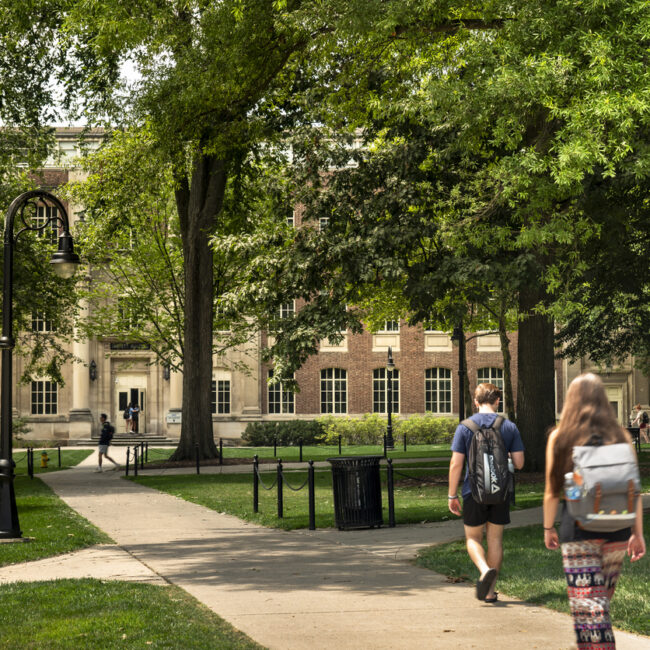 State College, Pennsylvania, USA - August 4, 2023:  Students walk along the paths of the University Park to the classroom lectures on the campus of Penn State university